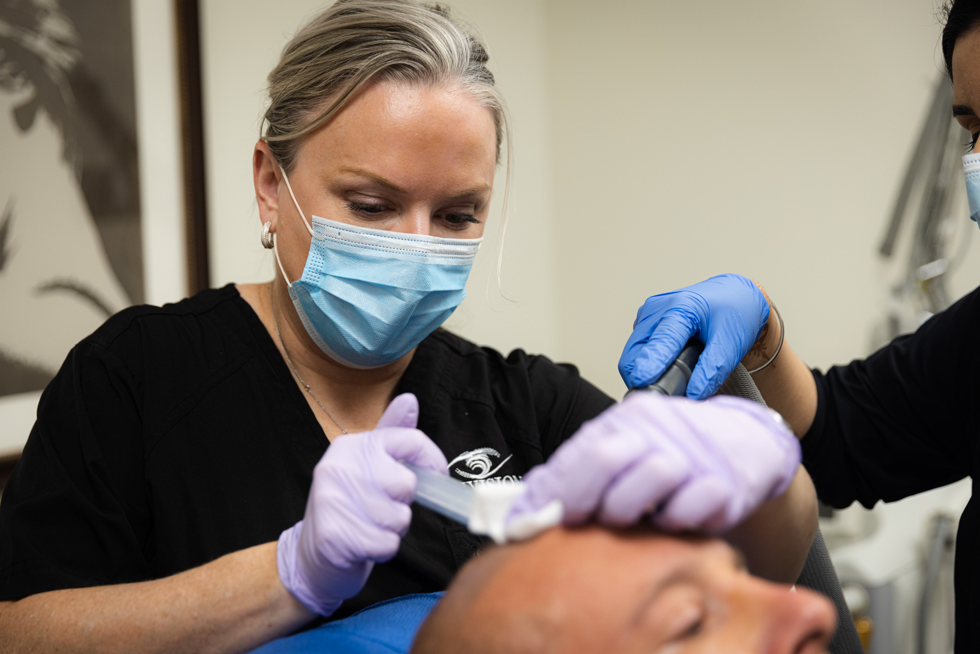 A specialist focuses on a PRP injection used on a relaxed patient's scalp.