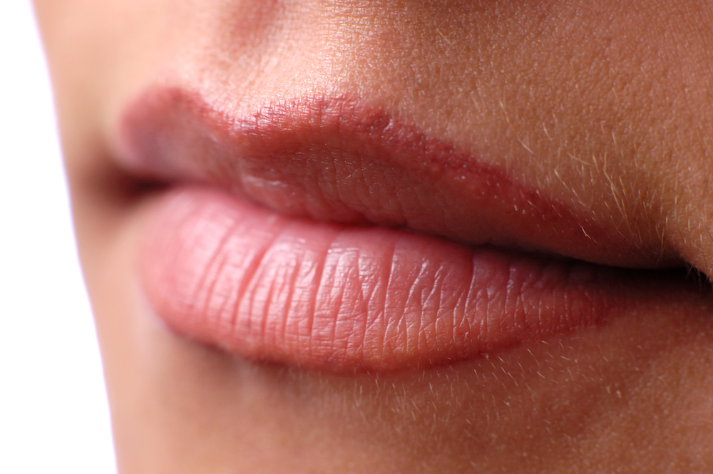 close up of woman's pink lined lips