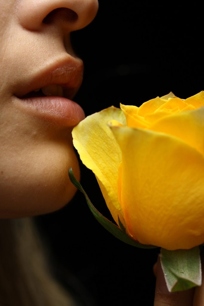 selective-focus-photography-of-woman-smelling-yellow-rose-1435690